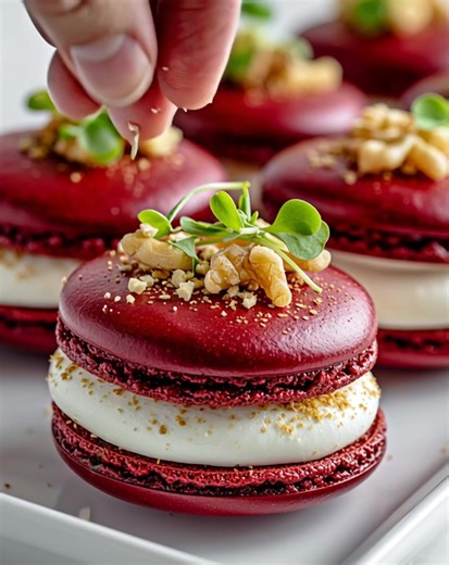 🌺 Savory Beet Macarons with Whipped Goat Cheese & Walnut Crunch Delicate beetroot shells sandwich a creamy goat cheese filling, crowned with crunchy walnuts for a bold, elegant bite. Ingredients Macaron Shells 1 cup almond flour 1 ½ cups powdered sugar 3 large egg whites (room temperature) ¼ cup granulated sugar 2 tbsp beetroot powder Pinch of salt Filling 6 oz goat cheese, softened 2 oz cream cheese 1 tbsp honey ½ tsp black pepper Topping ¼ cup chopped toasted walnuts Fresh microgreens for gar