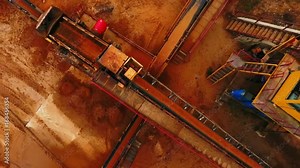 Mining industry. Process of sorting sand on mining conveyor belt. Sand moving on automated conveyor belt at sand quarry. Aerial view of mining equipment working at sand mine. Mining machinery