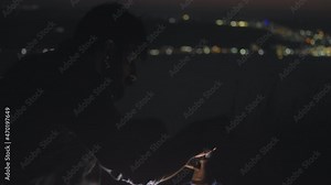 A bearded man preparing a traditional turkish coffee in a finjan coffee pot at night. Slow motion.