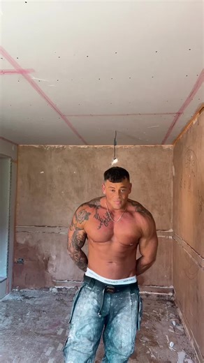 Muscular Plasterer in Construction Room Demonstration