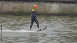 Extreme water sport. Fly Board on city river in park. Slow motion. Flyboard. Men Fly board flying on river. Kaliningrad - July 2017 Russian.