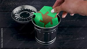 hand placing recycle symbol over opened garbage bin metaphor of eco-friendly habits Stock Video