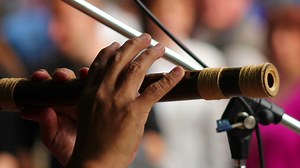Man plays the Native American instruments