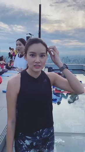 Yoga Session on Rooftop with City Skyline View