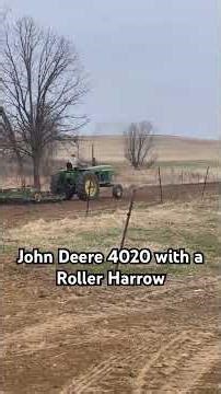 John Deere 4020 and a John Deere Roller Harrow (cultipacker)