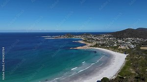 Wide panoramic view of the white sandy beach and the town of Bicheno in Tasmania, Australia.