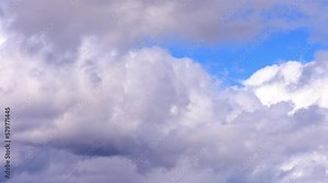 Time Lapse: Storm clouds billow and move through blue sky