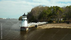 Scenic Aerial Footage of Doubling Point Lighthouse with Bath Iron Works visible in background, Arrowsic, Maine, USA