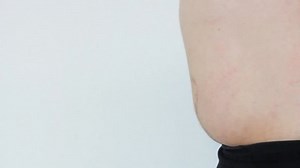 Fat Man With A Big Belly lets out his breathe and touches his stomach