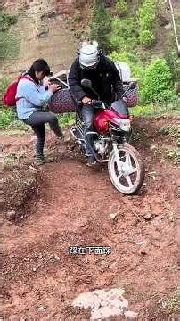 The motorcycle wheeled up, and a beautiful woman helped.