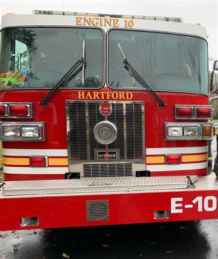 Snowy road conditions cause car to collide with fire truck in Hartford