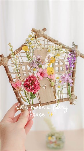 DIY fairy house weave made with sticks, jute string, and fresh wildflowers ✨ A nature inspired craft you can enjoy with kids on a walk collect sticks and flowers together, then create a tiny handmade fairy house. Start with a simple hexagon frame, wrap it in string, add windows and a door, and weave in the flowers for a magical finish. A slow, mindful activity perfect for creative play, forest school ideas, or anyone who loves nature crafts. Would you make one like this? Follow along for more Cr