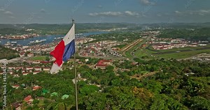 Panama City Aerial v65 panoramic view fly around national flag on ancon hill capturing port of balboa shipyard canal, historic district and downtown cityscape - Shot with Mavic 3 Cine - March 2022