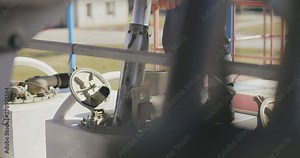 Refinery, gas and oil concept. Finish the process of filling the oil tank. Oil engineer checks oilpump in pipeline with special equipment. Closeup