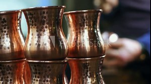 The copper master processes copper using various techniques. the master shapes the copper glass with the hammering technique. 4K. Soft focus .