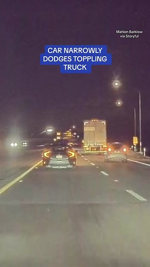 Dramatic footage shows the moment a driver NARROWLY dodged a toppling semi-truck. High winds appear to be a reason for the truck falling, according to California Highway Patrol (CHP) who spoke with Storyful. CHP also said that ‘no other vehicles were involved and no other vehicle collisions occurred,’ adding that there were no injuries reproted by the truck’s driver #fyp #highway #truck #driver #car #narrowlyavoided #police