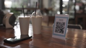Man are scanning the QR code to order food. Online payment is an additional payment method for customers. Mobile scanning system online for pay money and protect virus.