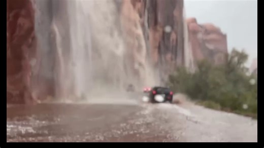 Travelers in Utah drive through waterfalls caused by flash flooding