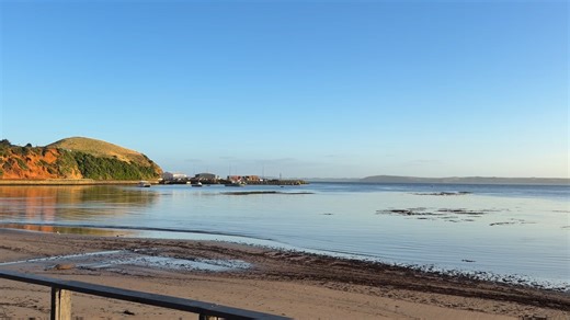Good morning from Rekohu ☀️🚴‍♀️ The only thing our cyclists have to worry about today… is the SUN! 😎 Just look at how bright it is — and the bay this morning? Dang… that’s flat as!! 🌊 Not a ripple in sight. Days like this on the Chatham Islands are pure magic — calm seas, big skies and open roads ahead. Cycling doesn’t get much better than this. #travelwithlesleywhyte #chathamislandtours #cyclingadventure #girlsontheroadagain #VisitChathamIslands | Travel With Lesley Whyte