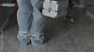 Forensic expert criminologist collects evidence at crime scene