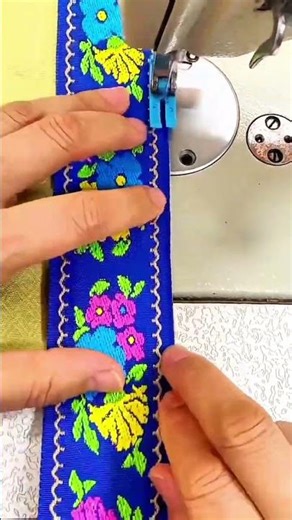Guiding multicolored fabric under sewing machine needle for decorative stitching pattern