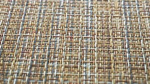 The texture of the fabric. Beige wicker fabric. Close-up. Can be used as a background.
