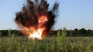Explosion on the field in summer. Detonation of bomb.