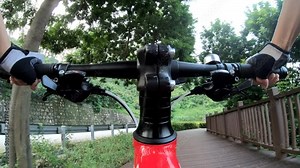 Riding bike on bicycle path in park, View from first person perspective POV - Point of view front by action camera