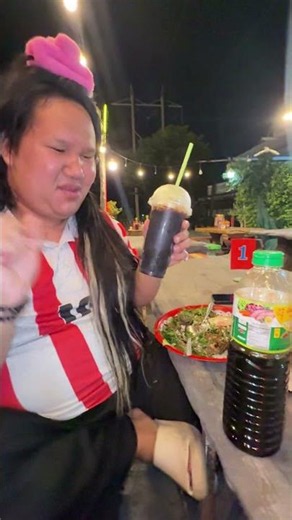 Sister Mintra drinks from the green lid.