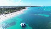 Aerial flight above the public Bavaro beach with white sand....