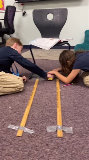 Fourth grade has been studying energy in science, and today they put their learning into action. Using large rubber bands, toy trucks, and measuring tools, students explored how stored energy works and measured its effects. | Emmanuel Lutheran School