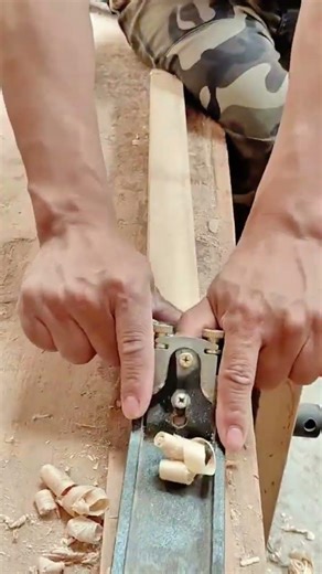 shaving wood using a hand plane tool for smoothing a surface and creating thin decorative shavings