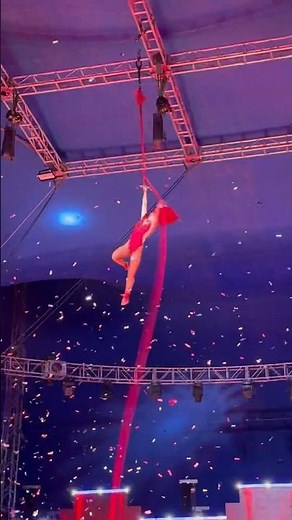 Dazzling Aerialist in Red: Stunning Confetti-Start Performance at Garden Brothers Circus 🎻✨