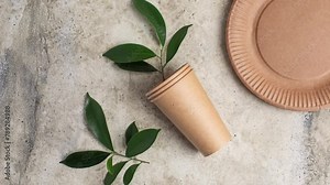 Eco friendly paper cup and green plant. Zero waste, plastic-free items. Stop plastic pollution.