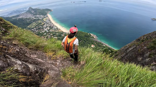 Wingsuit flying down the mountain straight to the beach