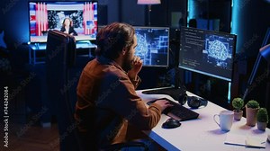 Freelancing programmer writes code on desktop PC to visualize artificial intelligence neural networks. Self employed man runs AI script on computer from apartment office, jib down shot