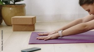 attractive yoga woman exercising healthy lifestyle practicing childs pose enjoying workout at home training on exercise mat