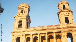 Classical French church on sunset light in front of a beautiful French fountain