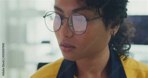 Close-up young Black female robotics engineer coding AI software for robotic arm in laboratory. Embedded system, firmware testing, machine learning, industrial automation, future technology concept.