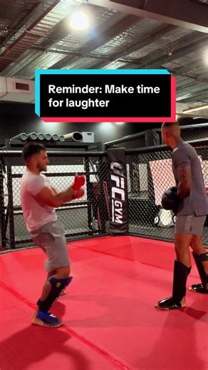 2 dads laughing while moving their body. Good to make time for laughter. Medicine.