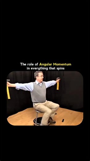 technologi_reel_ on Instagram: "Angular momentum sounds complex, but this simple demonstration makes it unforgettable. As the person spins on a stool, small changes in arm position completely change the speed of rotation. Arms out, the spin slows. Arms in, everything speeds up. Nothing magical—just physics doing exactly what it promises. This principle explains far more than a classroom trick. It’s why ice skaters pull their arms in to spin faster, why planets stay in stable orbits, and why bicy