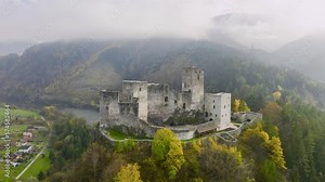 Slovak castles: an aerial view of Strečno Castle, towering on a cliff above the valley with the river Váh. Autumn, stone guard castle above the hilly landscape. Traveling Slovakia.