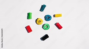 Circle of gummies of different colors moving, isolated on white background