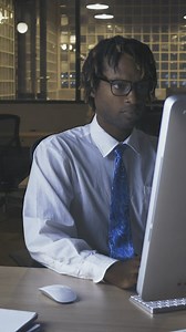 Male office worker working in an lonely office - Free Stock Video