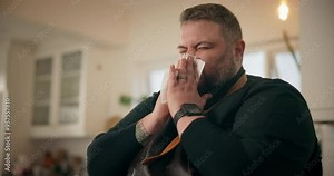 Sick, sneeze and man with tissue, allergies and sickness for cold symptoms or illness in kitchen. Chef, guy and virus with congested sinuses, toilet paper and fever with health issue and bacteria