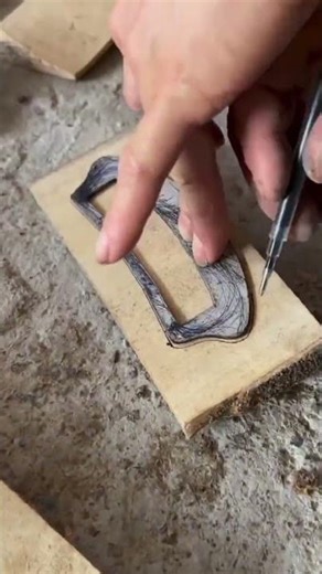 the process of tracing the shape of a door lock hole on wood.