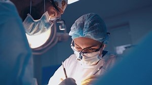 Doctor during surgery in operating room. Professional doctor performing operation in surgery room