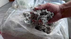 Cellulose insulation for walls and floors In hand. Recycled newsprint. Heat preservation and energy saving