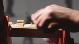 woodcarvers remove the excess from a piece of wood with a knife. the...