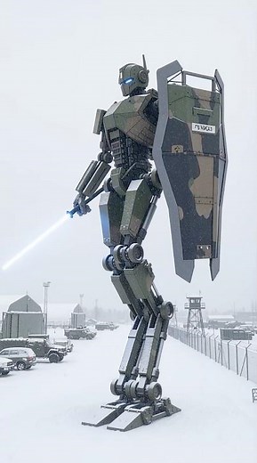 A snow covered military vehicle transforms into a futuristic bipedal robot weapon